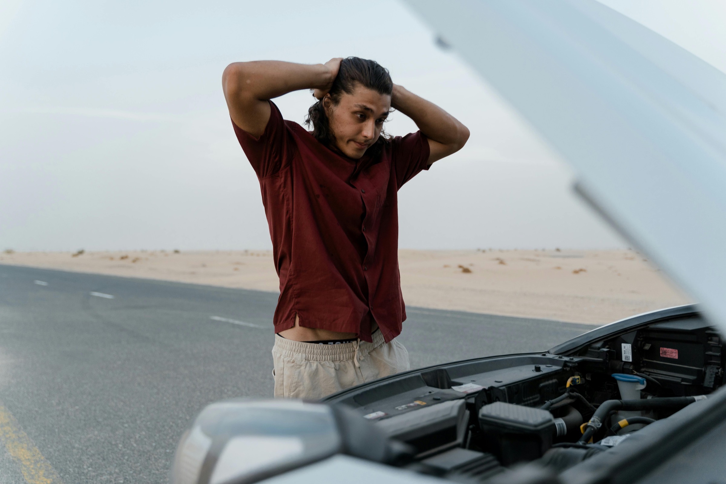 A man beside his broken-down car