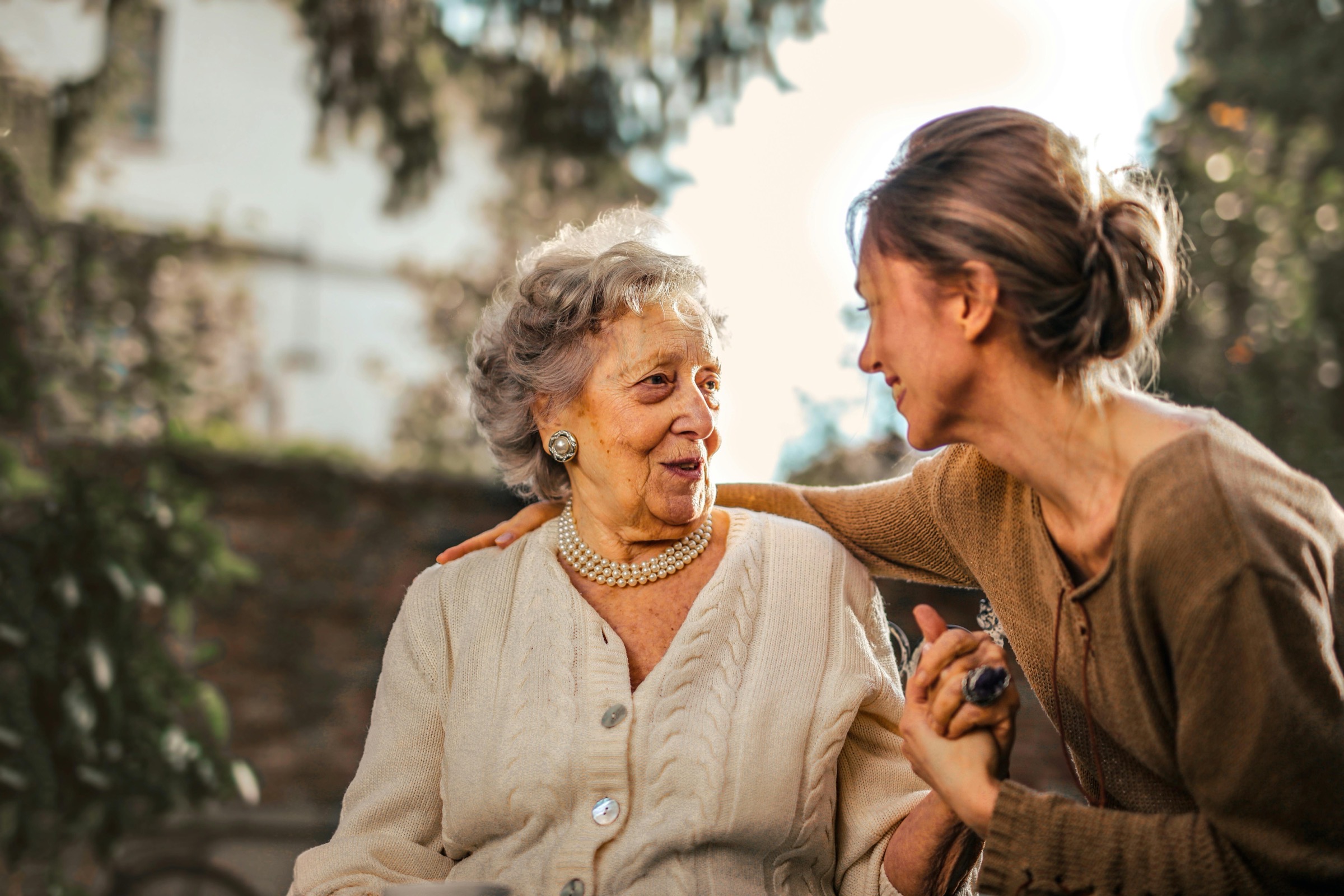Two women laughing together outdoors