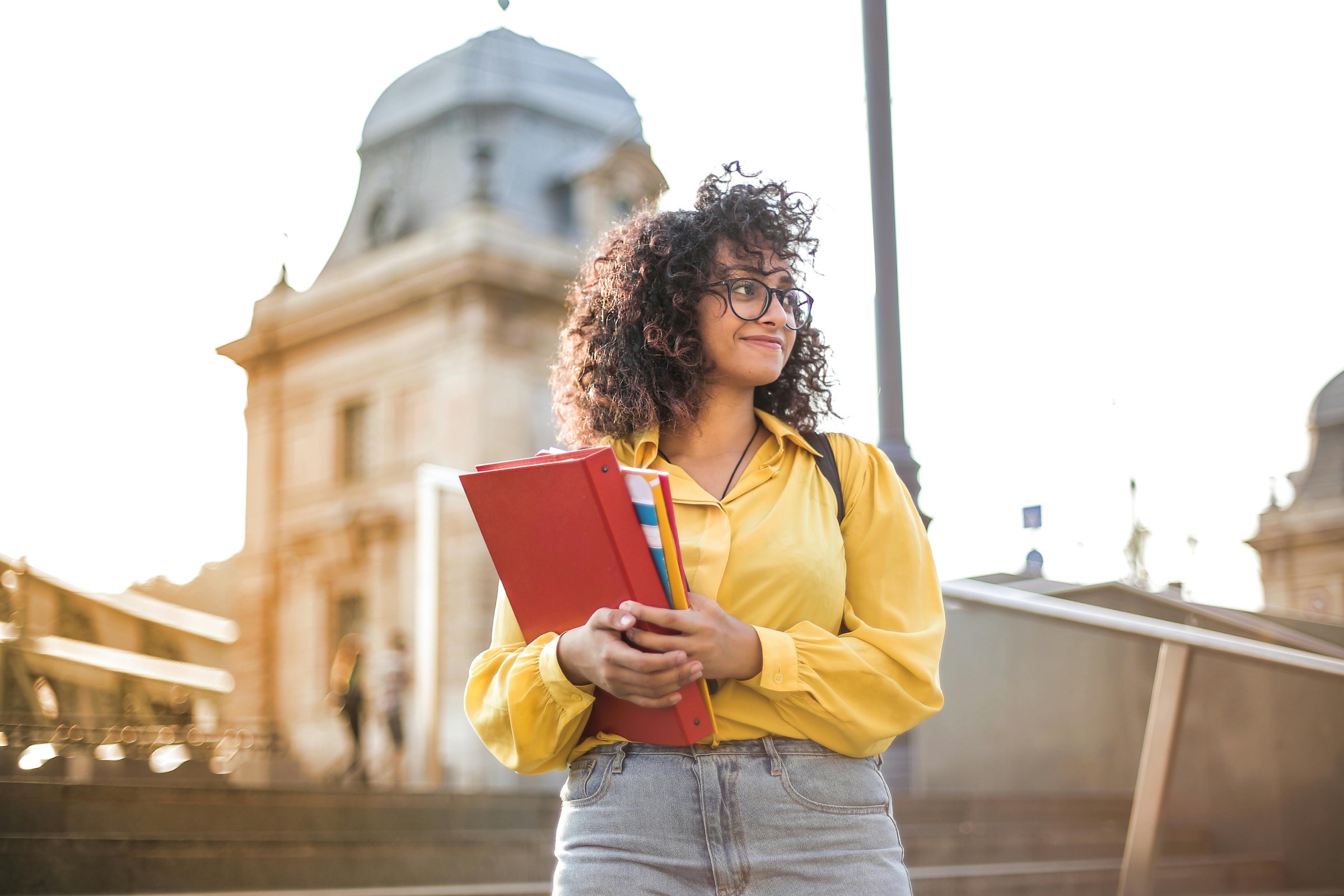 A student holding her books on campus